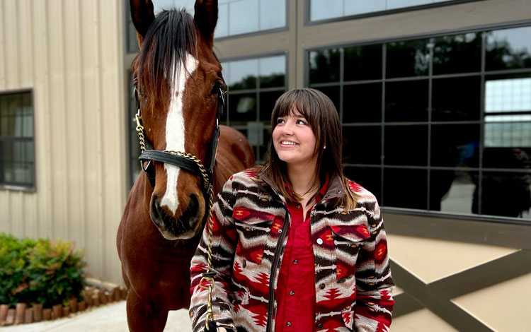 Abby looking at a Philly or colt standing outside the barn.